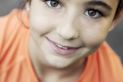 Clinician working with a school-age child on language activities